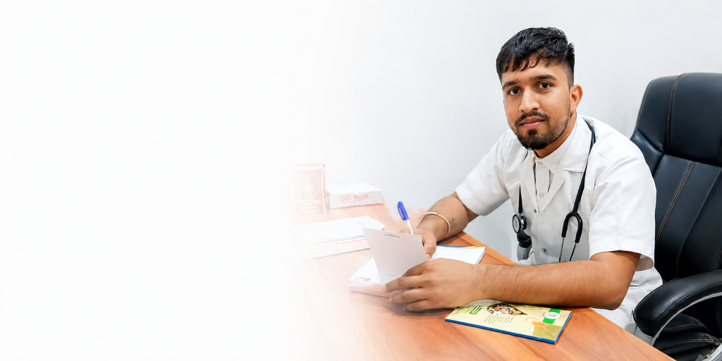 Dr. Jivan Singh sitting at his clinic desk